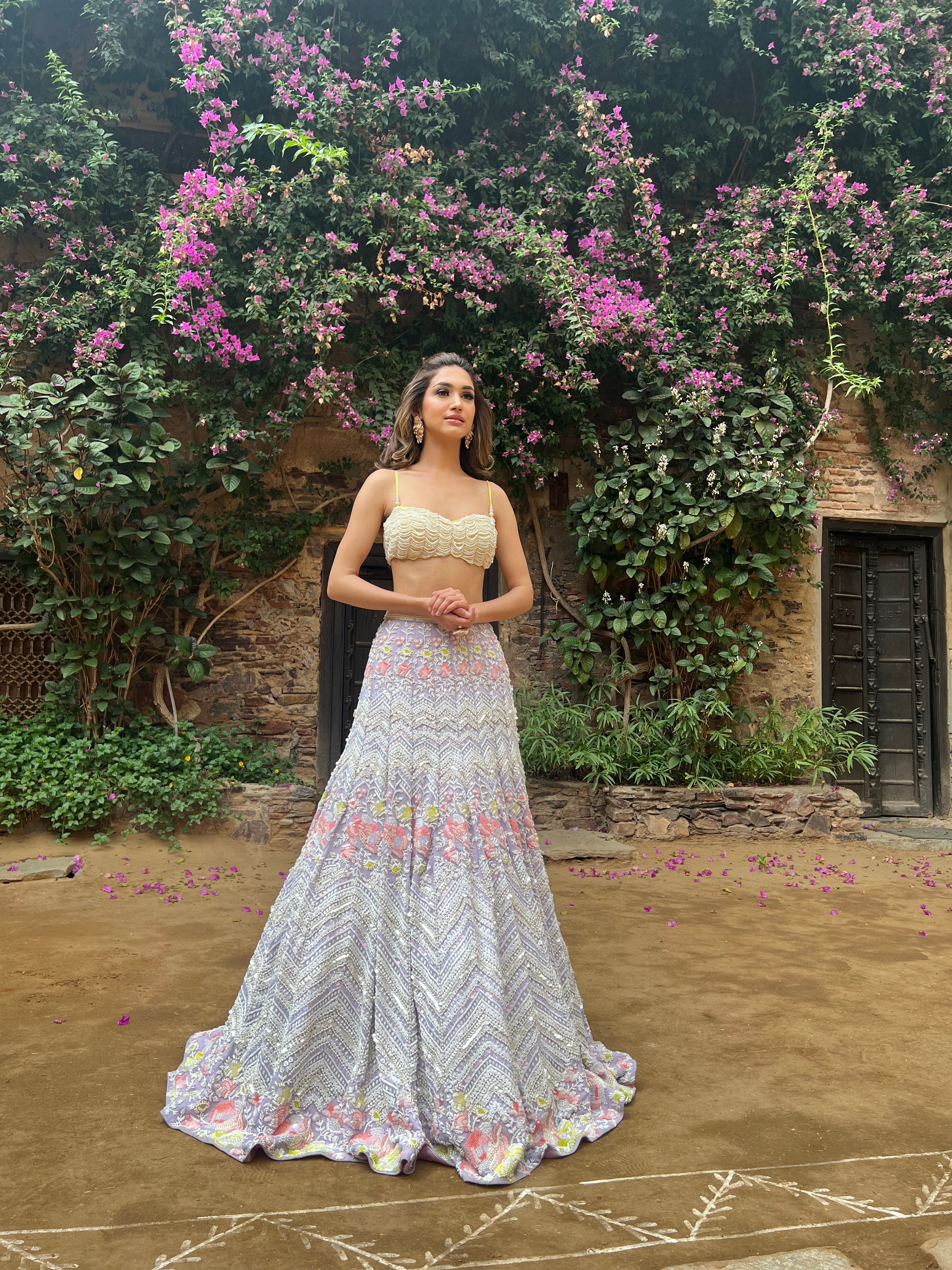 The Alara Mermaid Lehenga, a Cinderella-inspired bridal outfit, featuring a crystal tassel choli and a metallic georgette lehenga with intricate chevron and floral patterns.