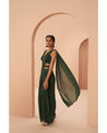 Bottled Beauty: Hand-embroidered elegance adorns this bottle green drape saree, a captivating symphony of sophistication.