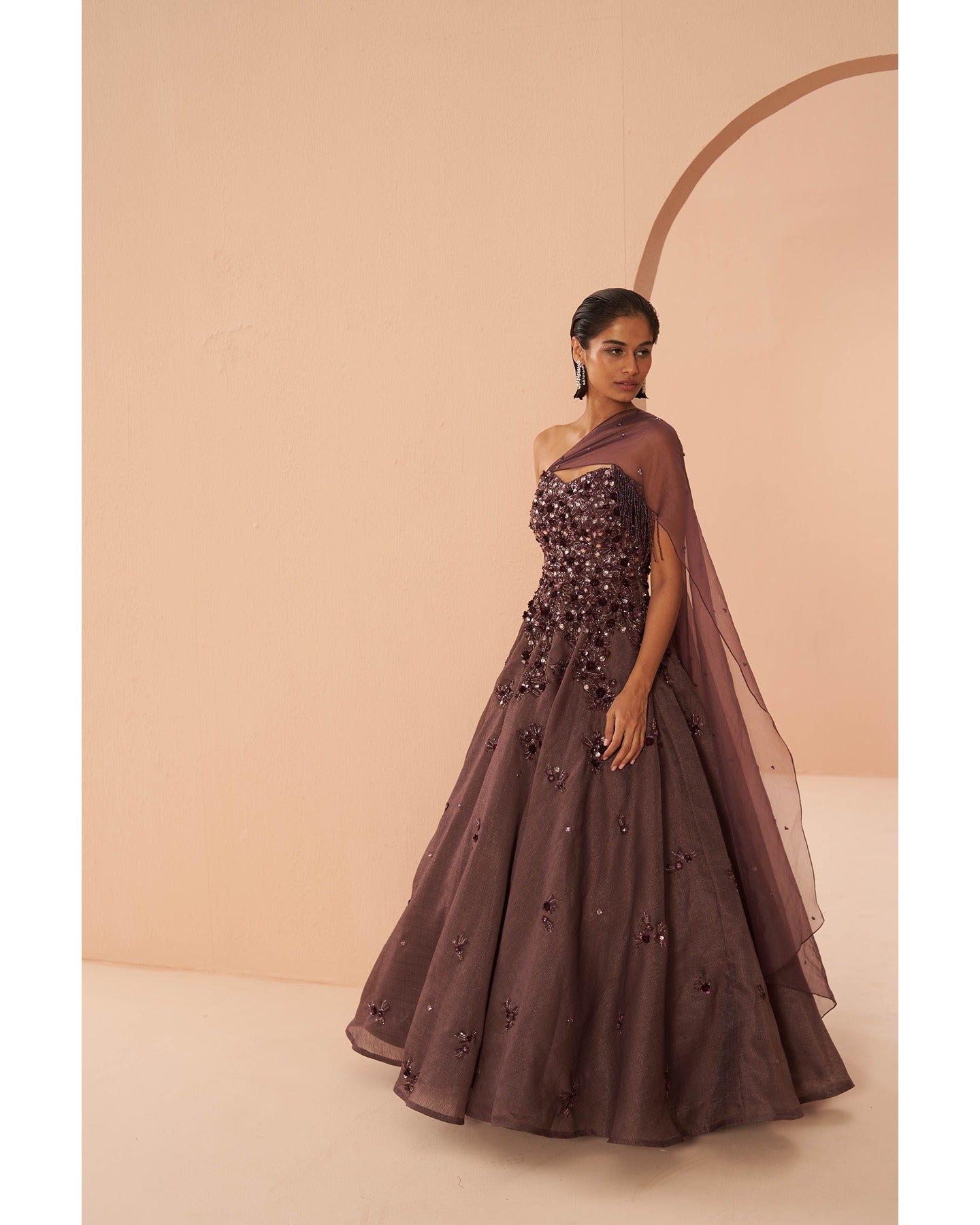 Wine Elegance: Adorned with intricate hand embroidery, this gown is a rich tapestry of sophistication and glamour.