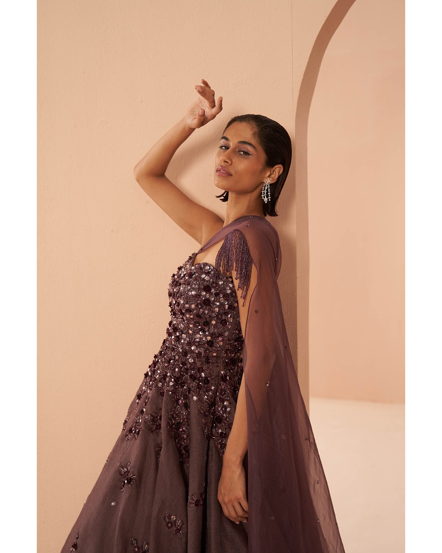 Wine Elegance: Adorned with intricate hand embroidery, this gown is a rich tapestry of sophistication and glamour.