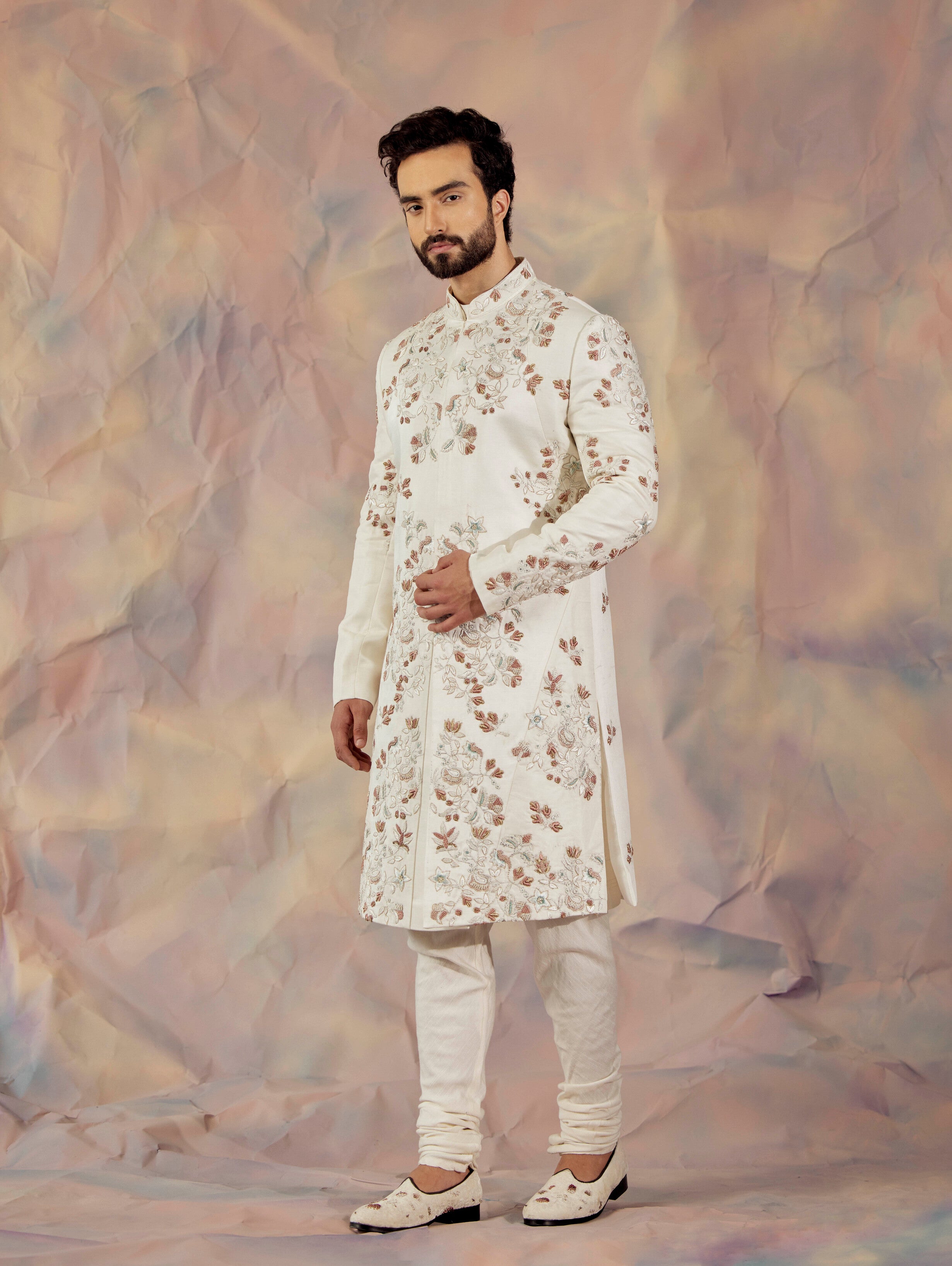 Step into timeless sophistication with the Ivory in Malaga Sherwani Set.