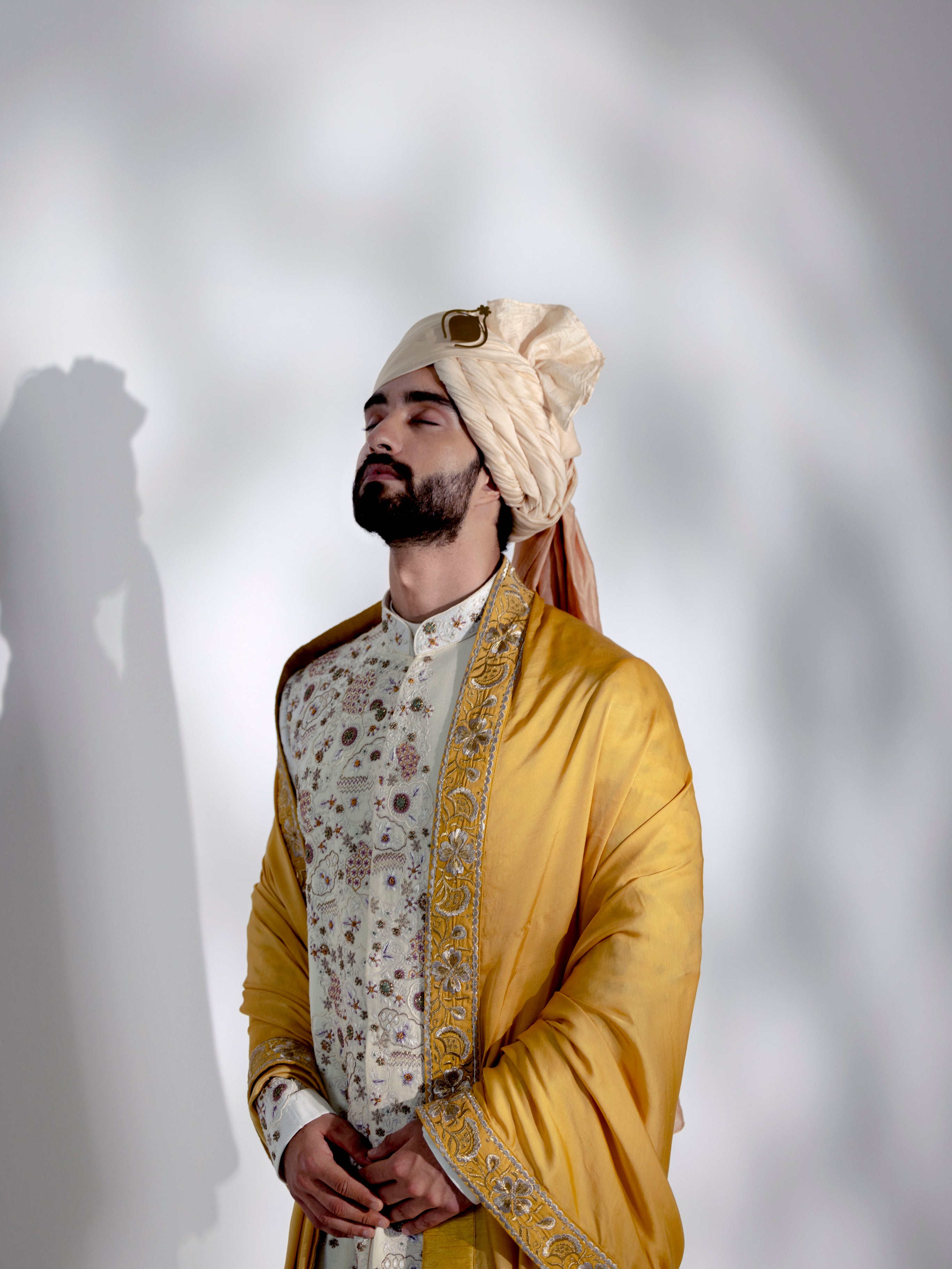 Step into timeless sophistication with the Ivory in Malaga Sherwani Set.