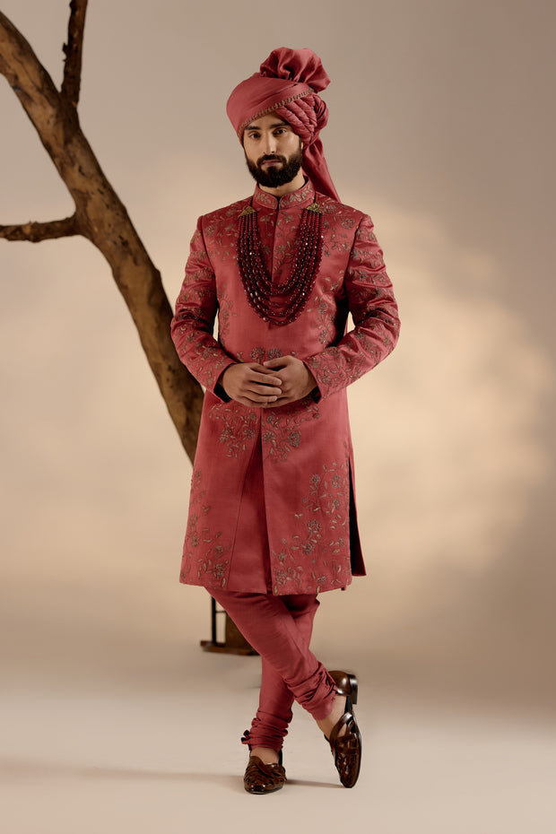 Model showcasing the Red Ochre Sherwani, radiating elegance with its deep red ochre hue