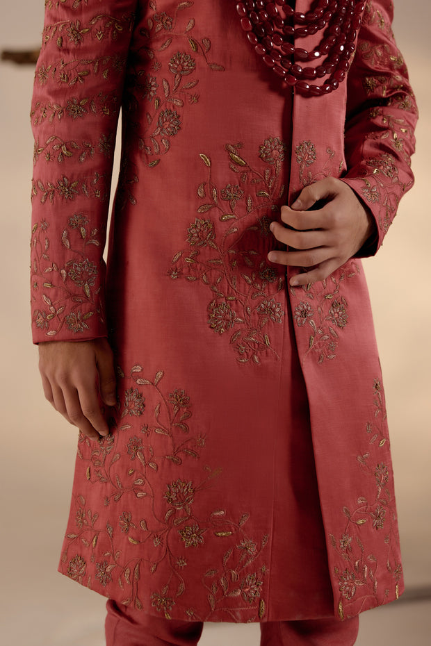 Side profile of the Red Ochre Sherwani, displaying the luxurious fabric and subtle sheen.