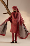 Full view of the Red Ochre Sherwani on a mannequin, highlighting its refined and regal silhouette