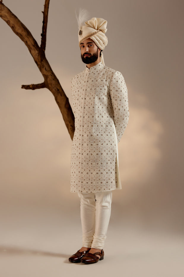 Close-up of the Albino White Sherwani, revealing intricate embroidery and fine detailing.
