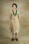 Model wearing the Sandune Sherwani, showcasing its elegant design and neutral tones