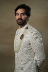Side profile of the Ivory & Gold Sherwani, displaying the rich ivory fabric and shimmering gold accents