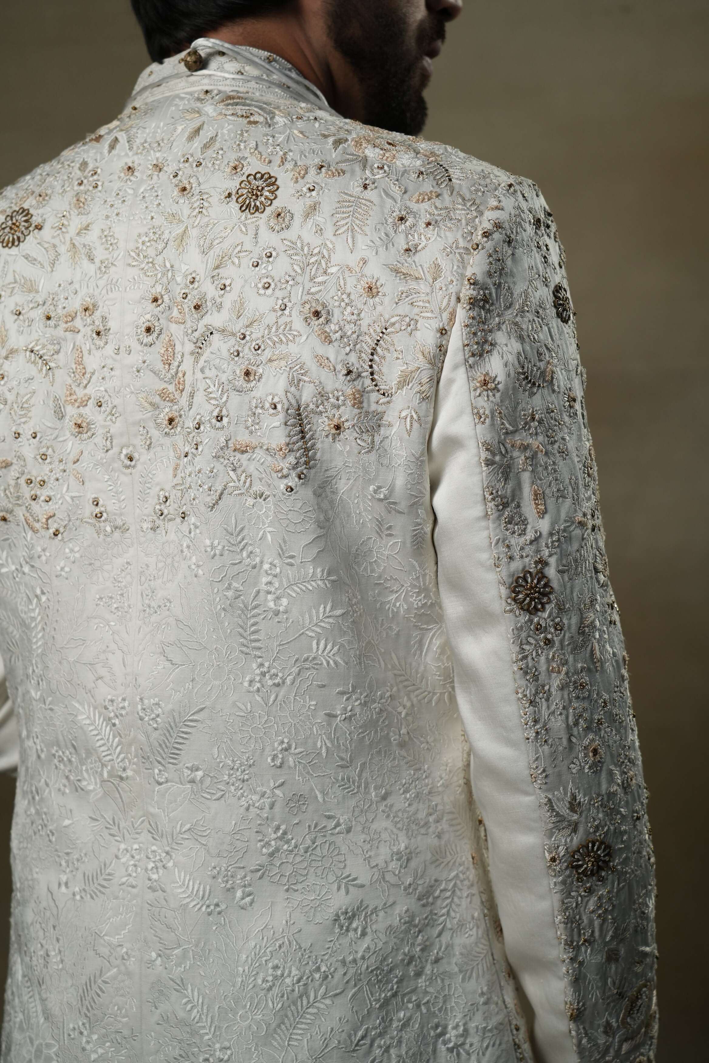 Back view of the Ivory & Gold Sherwani, featuring ornate gold embellishments and a tailored fit.