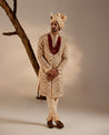 Model showcasing the Pale Gold Sherwani, radiating opulence with its golden hue.