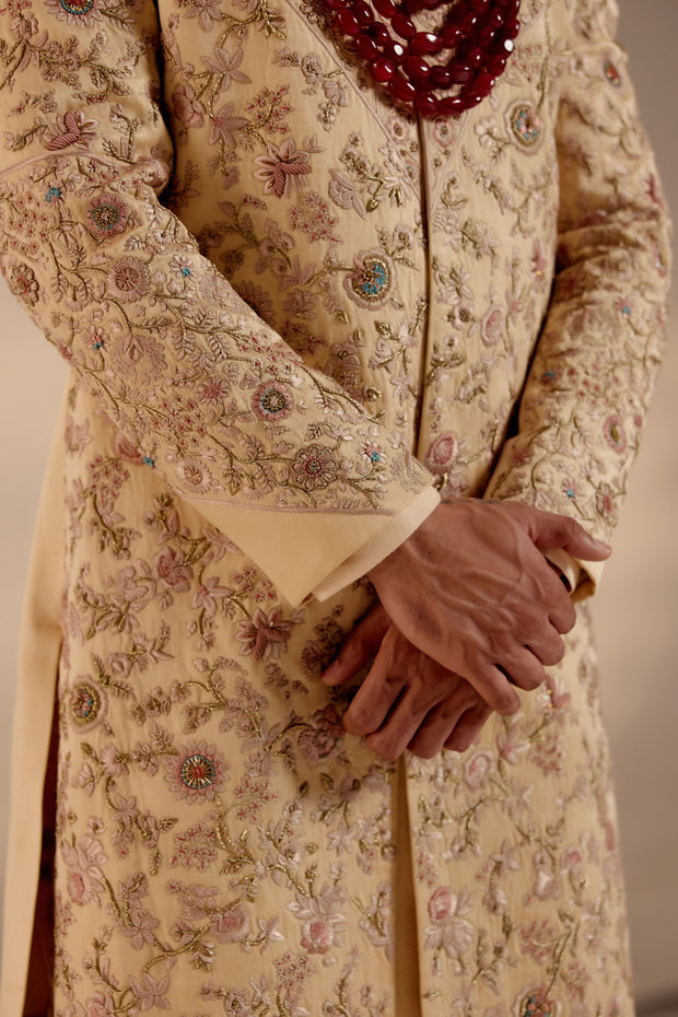 Close-up of the Pale Gold Sherwani, revealing intricate embroidery and luxurious detailing.