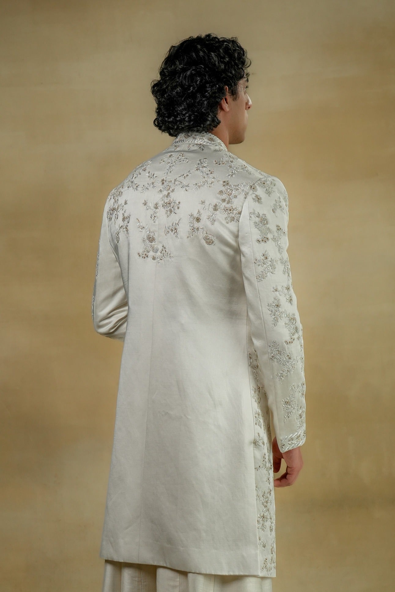 Back view of the Gardenia White Sherwani, featuring understated embellishments and a tailored fit.