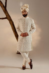 Introducing our renowned Kashmiri Jamawar embroidered sherwani, crafted in a captivating dirty ivory hue and adorned with intricate floral design details