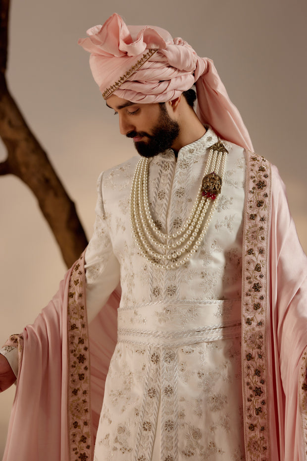 Introducing our exquisite white all-over hand-embroidered sherwani set, a true masterpiece of craftsmanship and elegance.