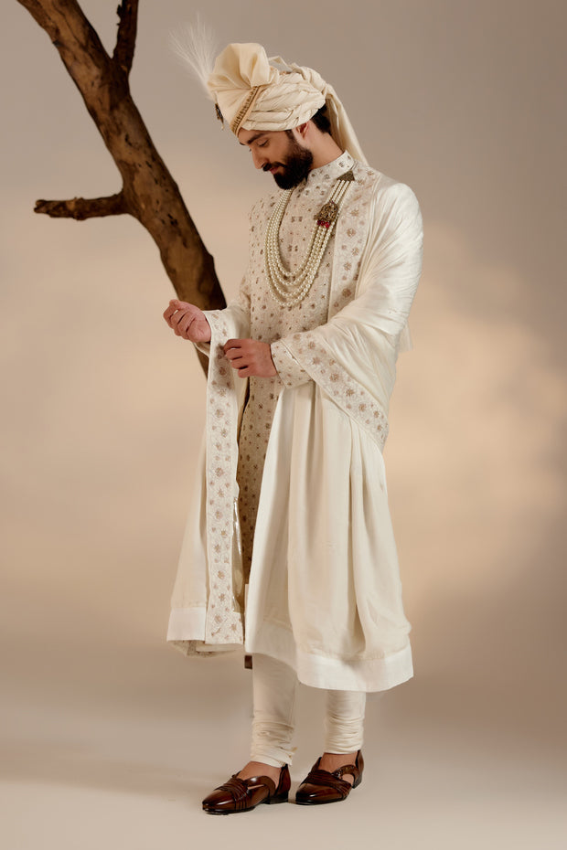 Introducing our renowned Kashmiri Jamawar embroidered sherwani, crafted in a captivating dirty ivory hue and adorned with intricate floral design details. 