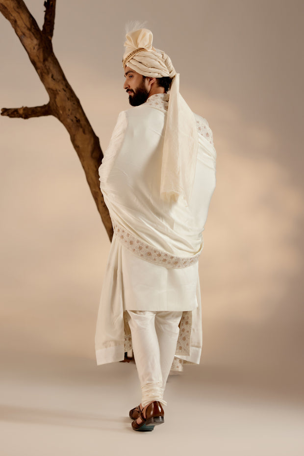Introducing our renowned Kashmiri Jamawar embroidered sherwani, crafted in a captivating dirty ivory hue and adorned with intricate floral design details. 
