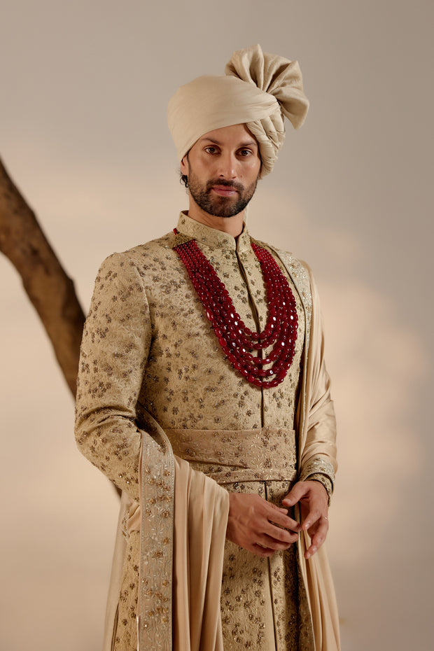 Introducing our exquisite sand grey all-over hand-embroidered sherwani set, a true work of art.