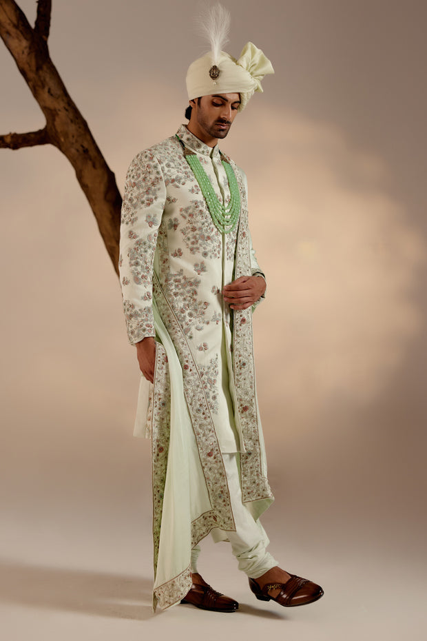 the hazy blue heavily embroidered placement sherwani, a true standout piece for your sundowner wedding.