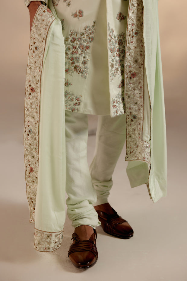 the hazy blue heavily embroidered placement sherwani, a true standout piece for your sundowner wedding.