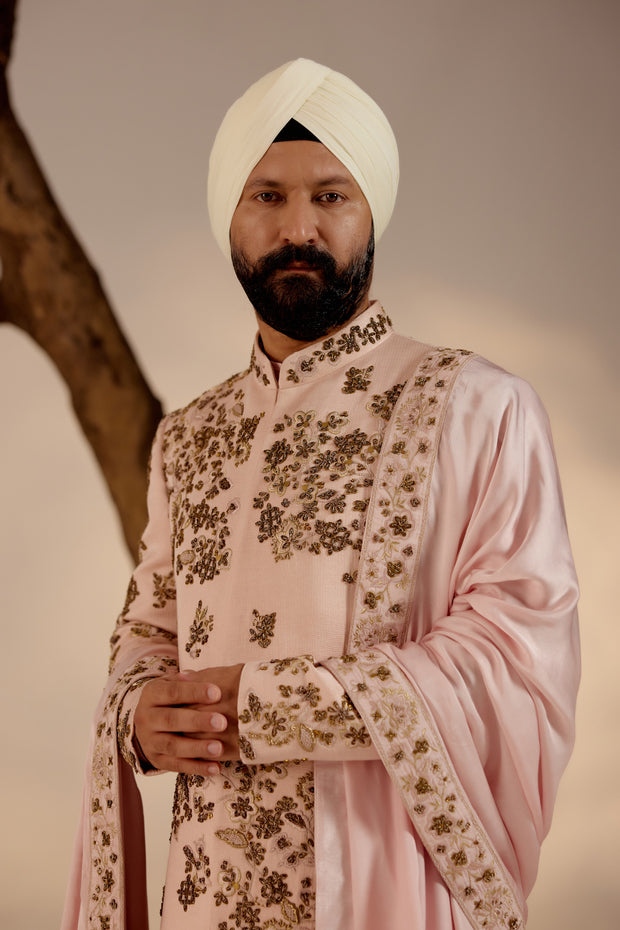 Introducing our exquisite hand-embroidered shell-pink sherwani, a true work of art.