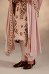 Introducing our exquisite hand-embroidered shell-pink sherwani, a true work of art.
