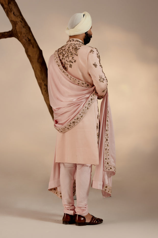 Introducing our exquisite hand-embroidered shell-pink sherwani, a true work of art.'
