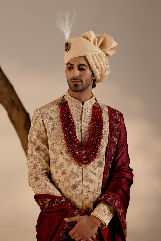 This sherwani features an intricate embroidery technique combining zardozi and aari work, showcasing unparalleled craftsmanship and detail.