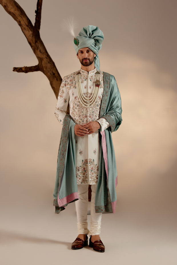 Introducing our ivory placement hand-embroidered sherwani set, a true epitome of elegance and craftsmanship.