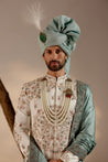 Introducing our ivory placement hand-embroidered sherwani set, a true epitome of elegance and craftsmanship.