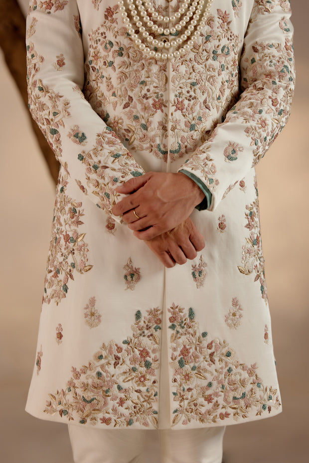 Introducing our ivory placement hand-embroidered sherwani set, a true epitome of elegance and craftsmanship.'