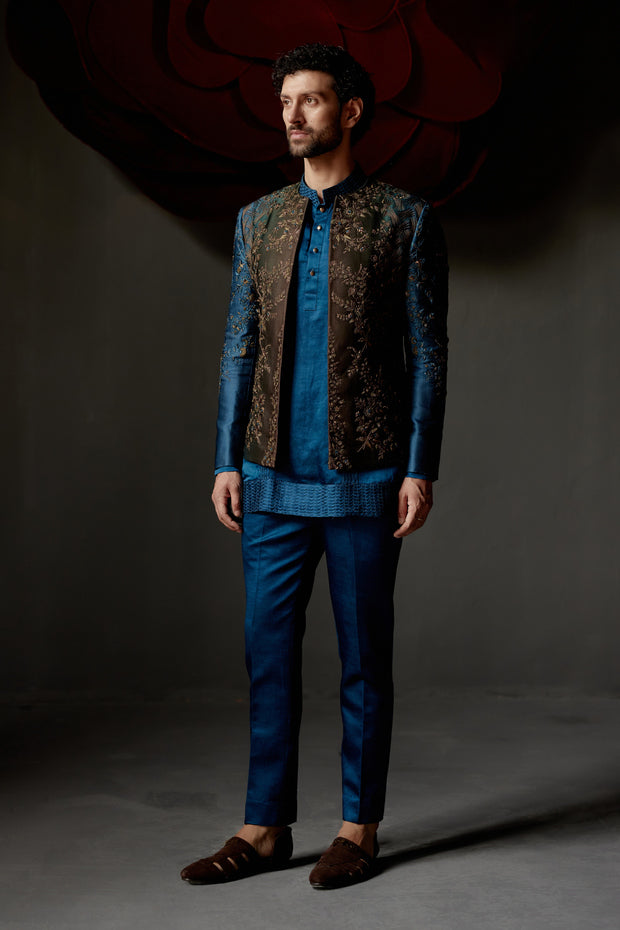 This exquisite piece is hand-embroidered using the traditional zardozi technique, featuring intricate three-color thread work and highlighted with shimmering gold sequins