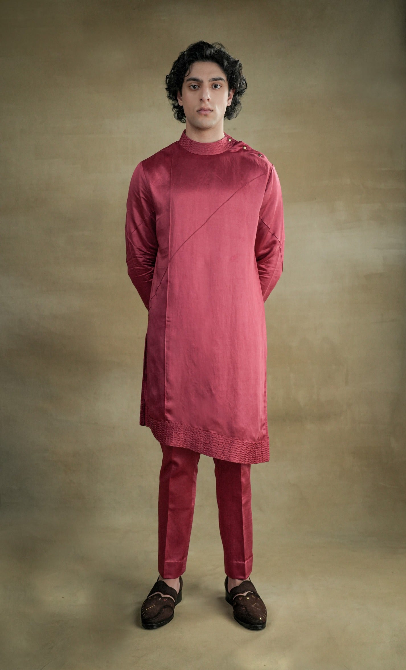 Bohemian scarlet kurta set with a relaxed-fit tunic adorned with tassels and embroidery, paired with loose-fitting trousers for a free-spirited and whimsical vibe