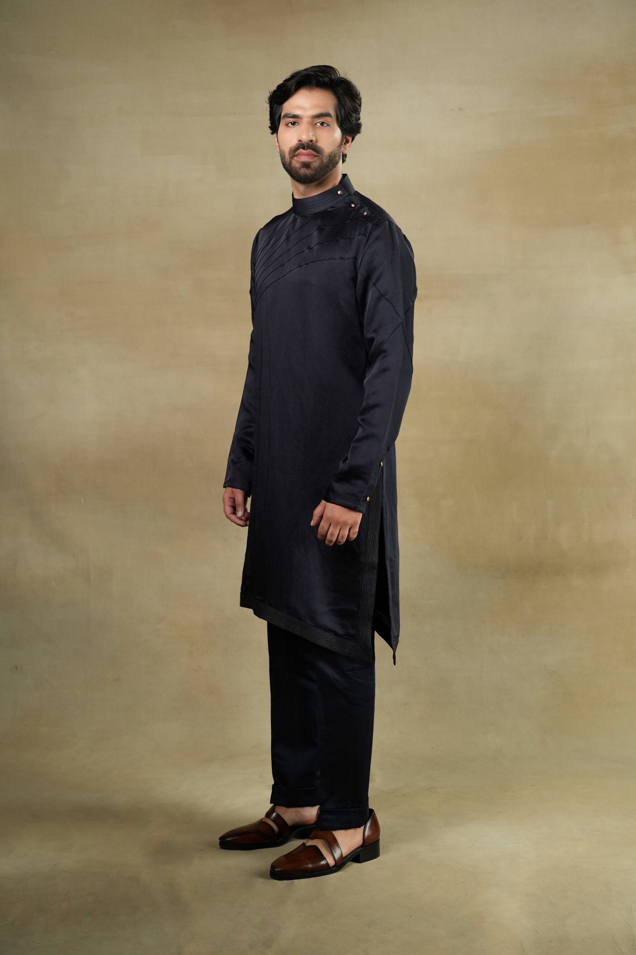 Elegant Midnight Wane Kurta Set featuring a dark blue kurta with intricate golden embroidery, paired with matching trousers for a sophisticated and regal look
