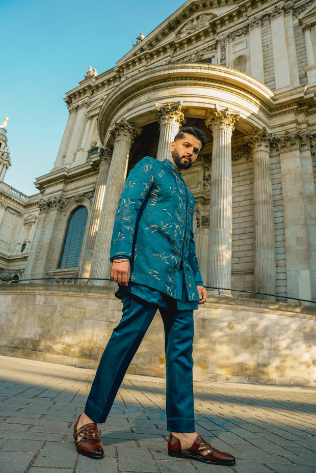 Teal blue bandhgala with colorful resham thread detailing and tone-on-tone embroidery, paired with a matching shirt kurta and tapered trousers