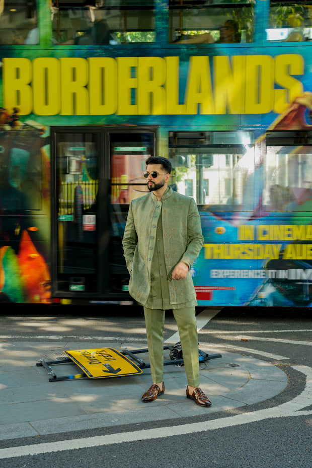 Sage green long bandhgala with tone-on-tone doriwork and a parallel front border, paired with a pintuck collar kurta and tapered trousers