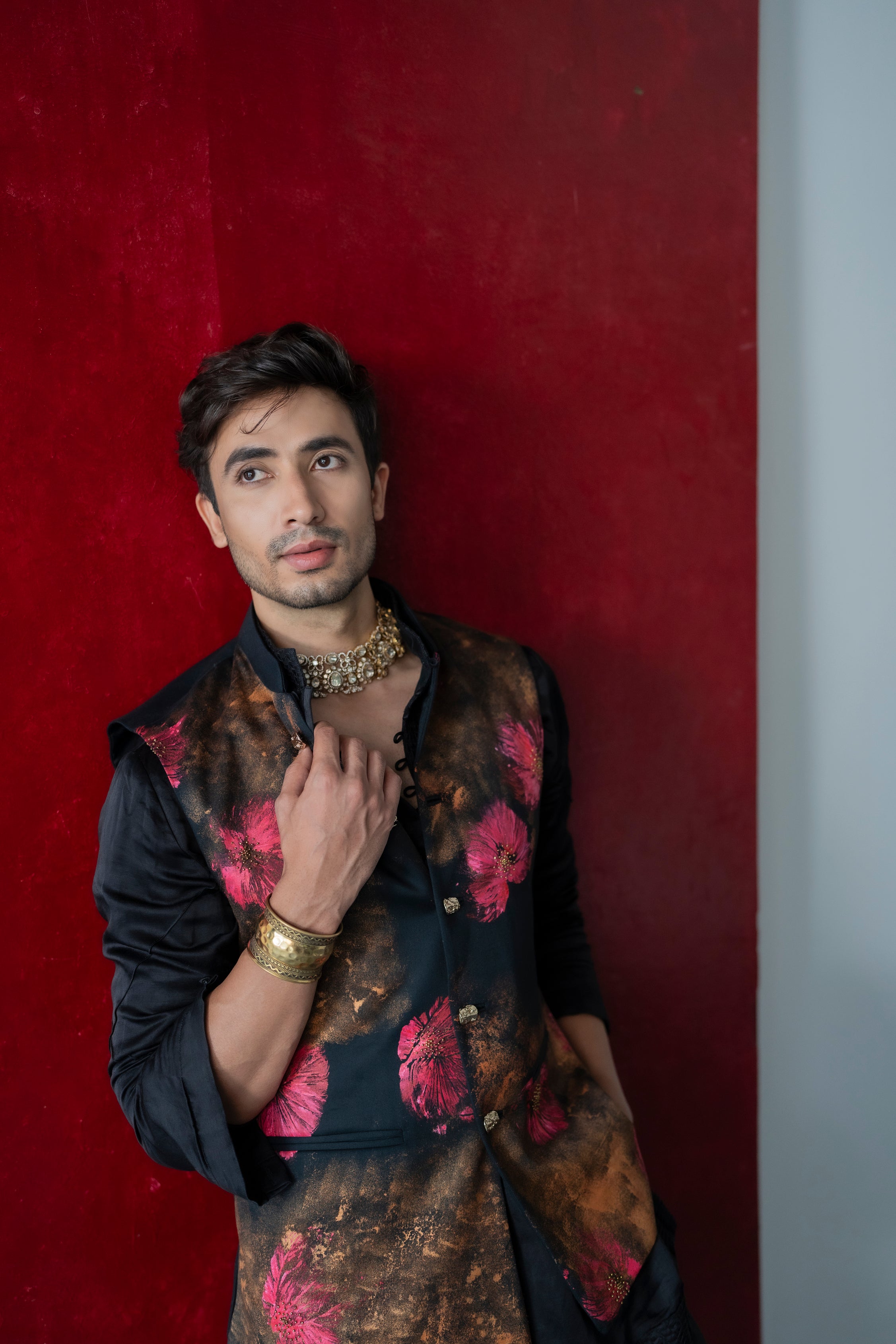 Deep Fuschia Nehru Jacket set on a black base, featuring gold sponge paint splashes and fuchsia pink abstract flowers, paired with a black kurta and tapered trousers.