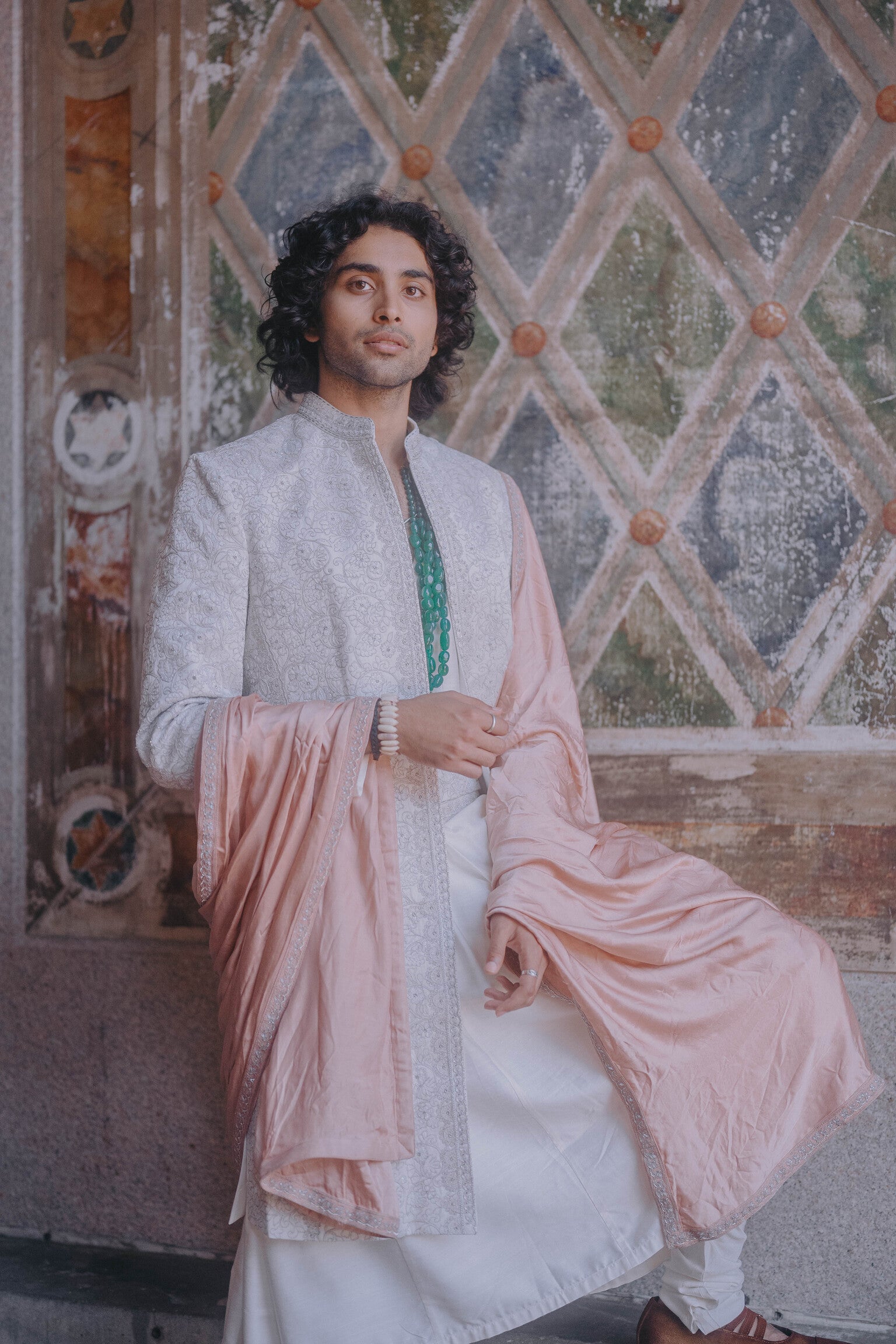 Ivory open sherwani in linen silk with tone-on-tone floral embroidery, paired with an anarkali kurta, churidar, embroidered kamarbandh, and an old rose stole