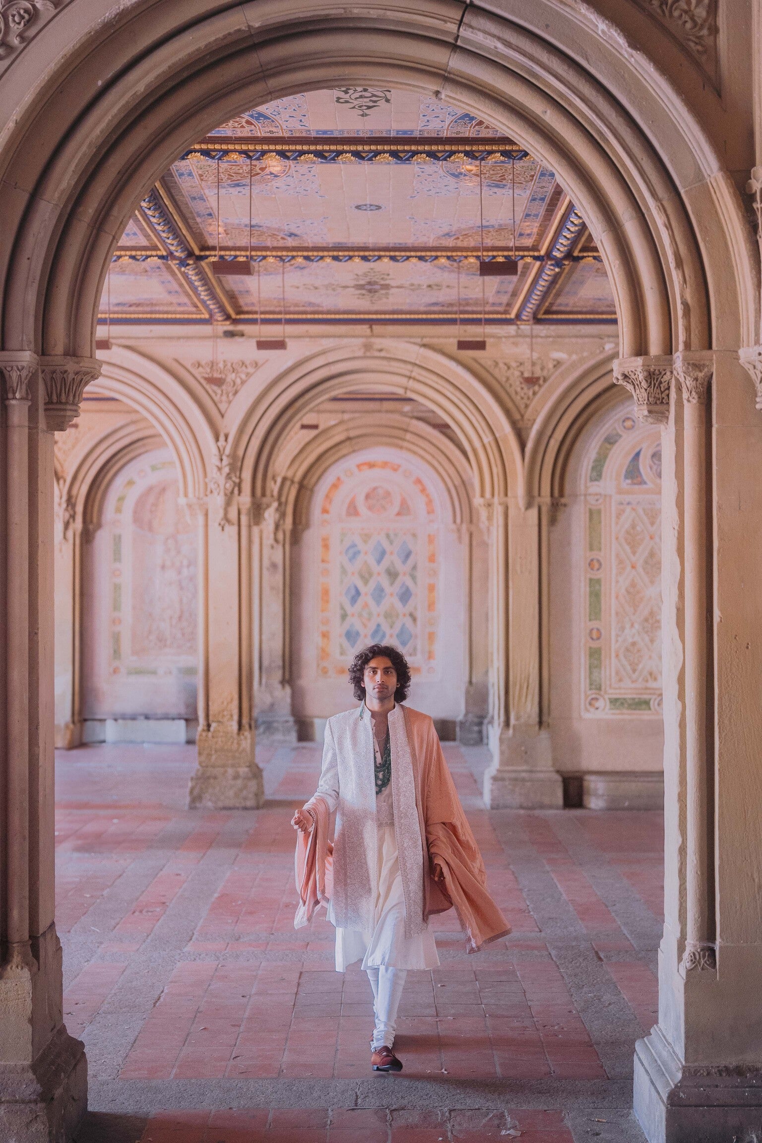 Ivory sherwani in linen silk featuring floral embroidery with dori work and katdana, styled with an anarkali kurta, churidar, embroidered double border kamarbandh, and an old rose stole.