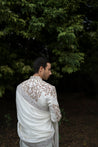 Back view of the Ivory Fleur sherwani, highlighting the elegant placement embroidery and subtle shimmer of sequins and gold elements on the linen silk base.