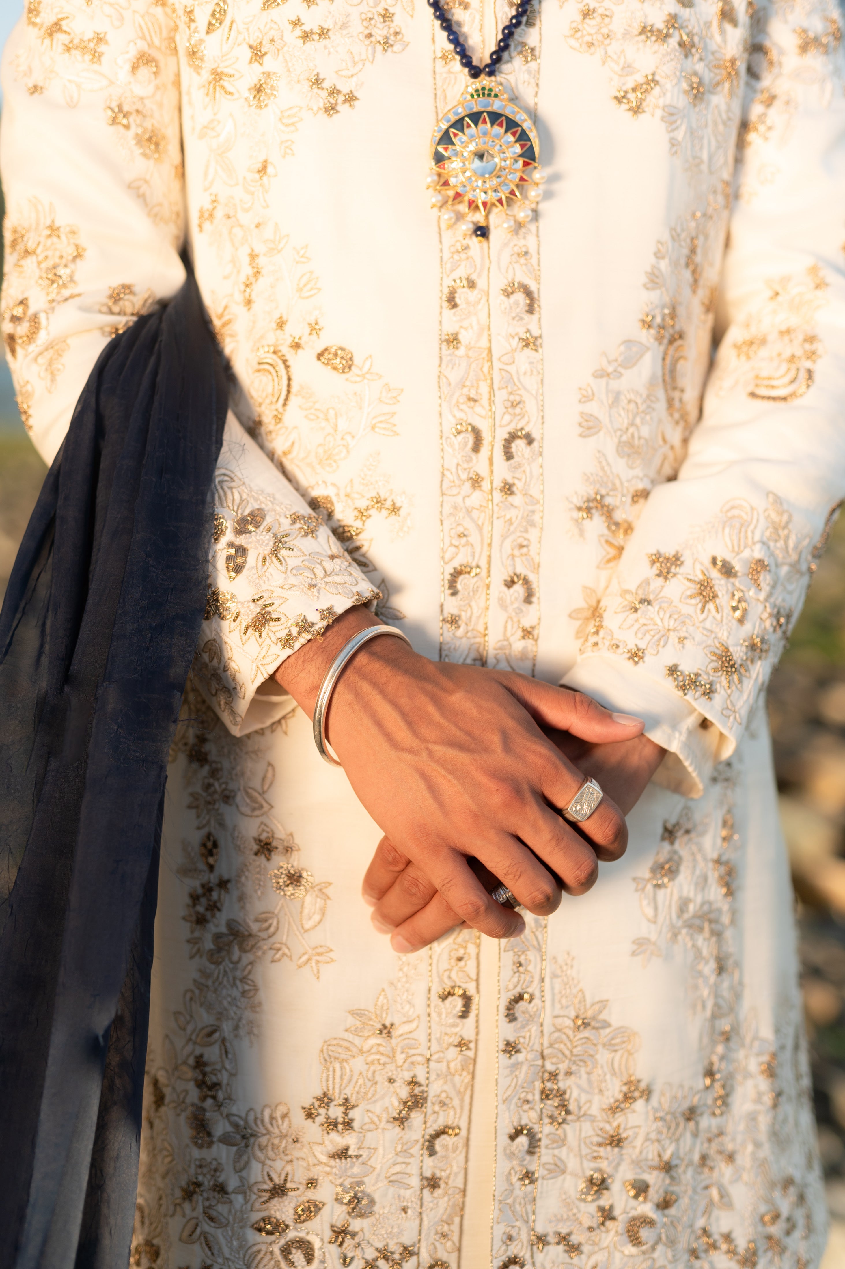 Full outfit of a greyish lilac short jacket set paired with a short-length shirt-style kurta and tapered trousers, creating a chic and modern look