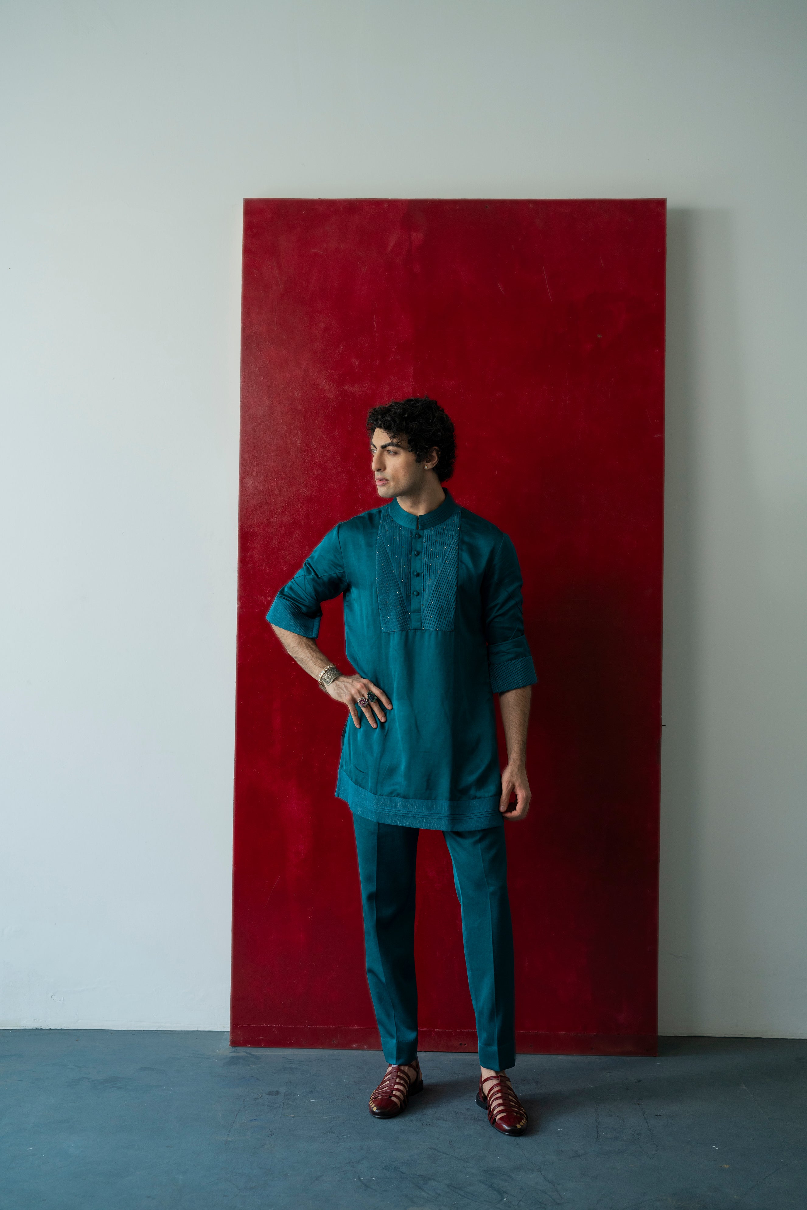 The Jade Tamarisk Kurta Set in a vibrant teal green color, featuring crinkled georgette fabric detailing adorned with antique moti, paired with matching tone-on-tone tapered trousers