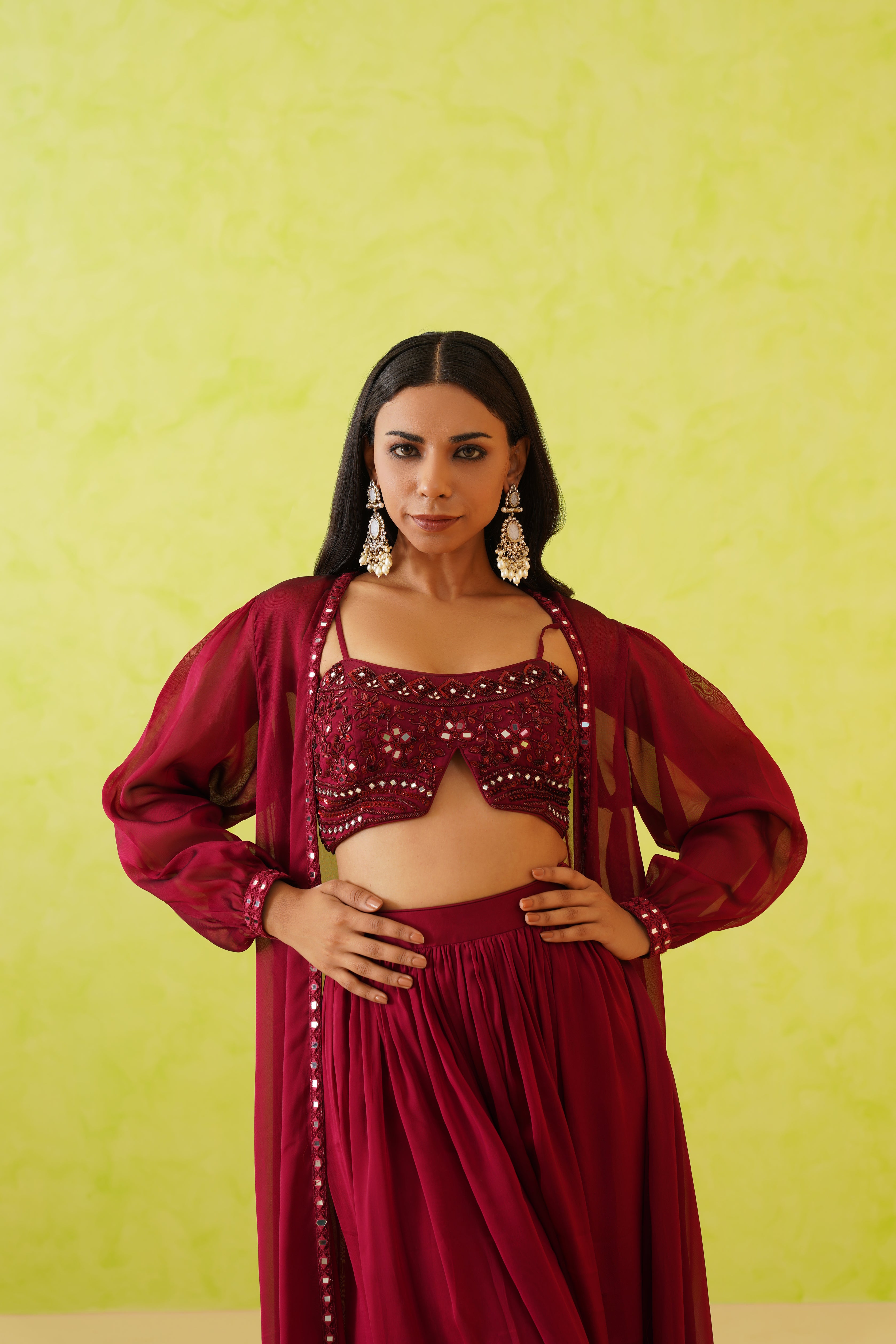 Elegant maroon crop top and skirt set featuring intricate crystal, mirror, and resham embroidery for a stunning look.