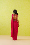 Flowy, full-length modern saree in fuchsia pink, enhanced by a glamorous detachable belt that adds sophistication to the look.