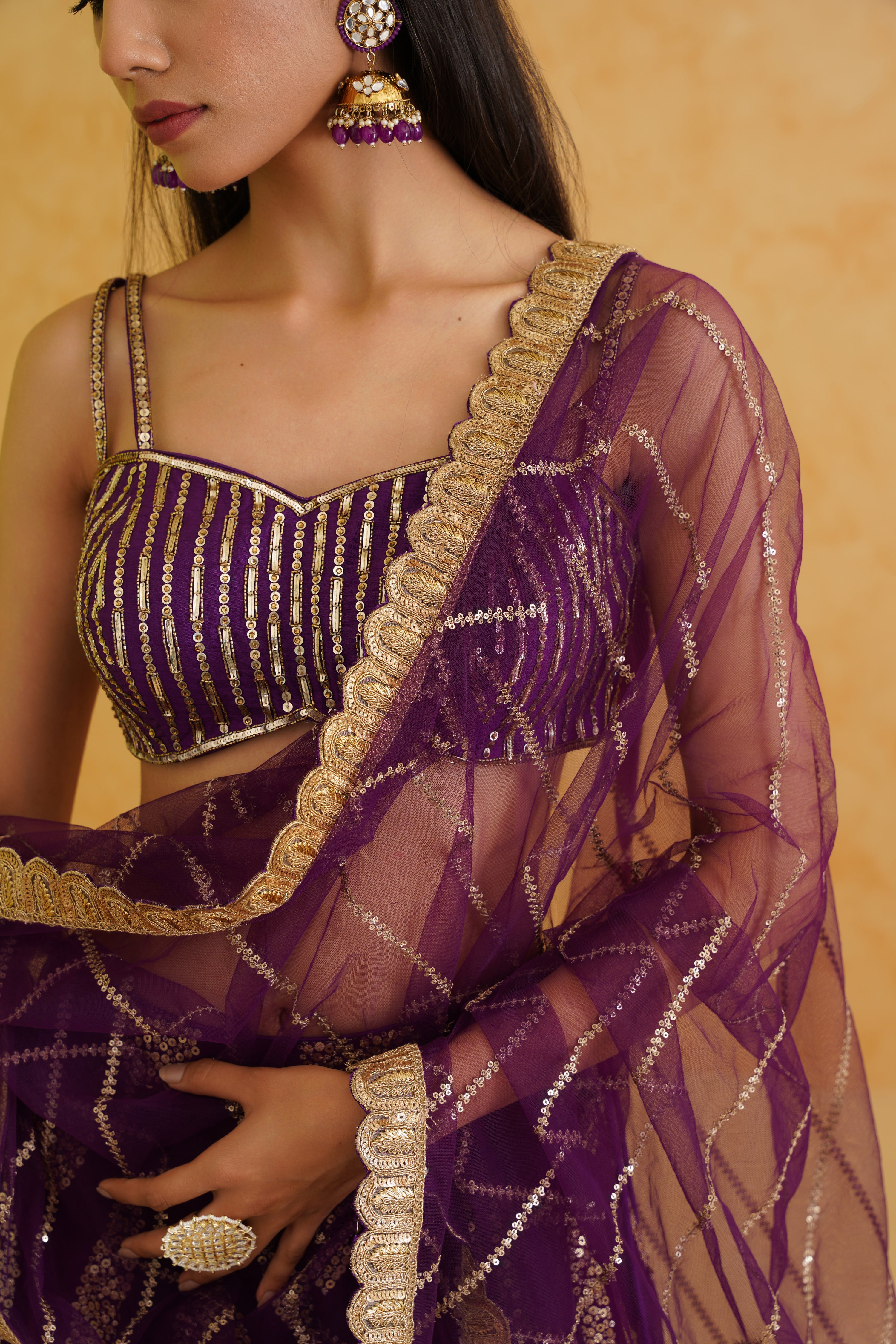 Chic net texture of the lehenga ensures comfort, complemented by a stylish purple net dupatta for a complete look.