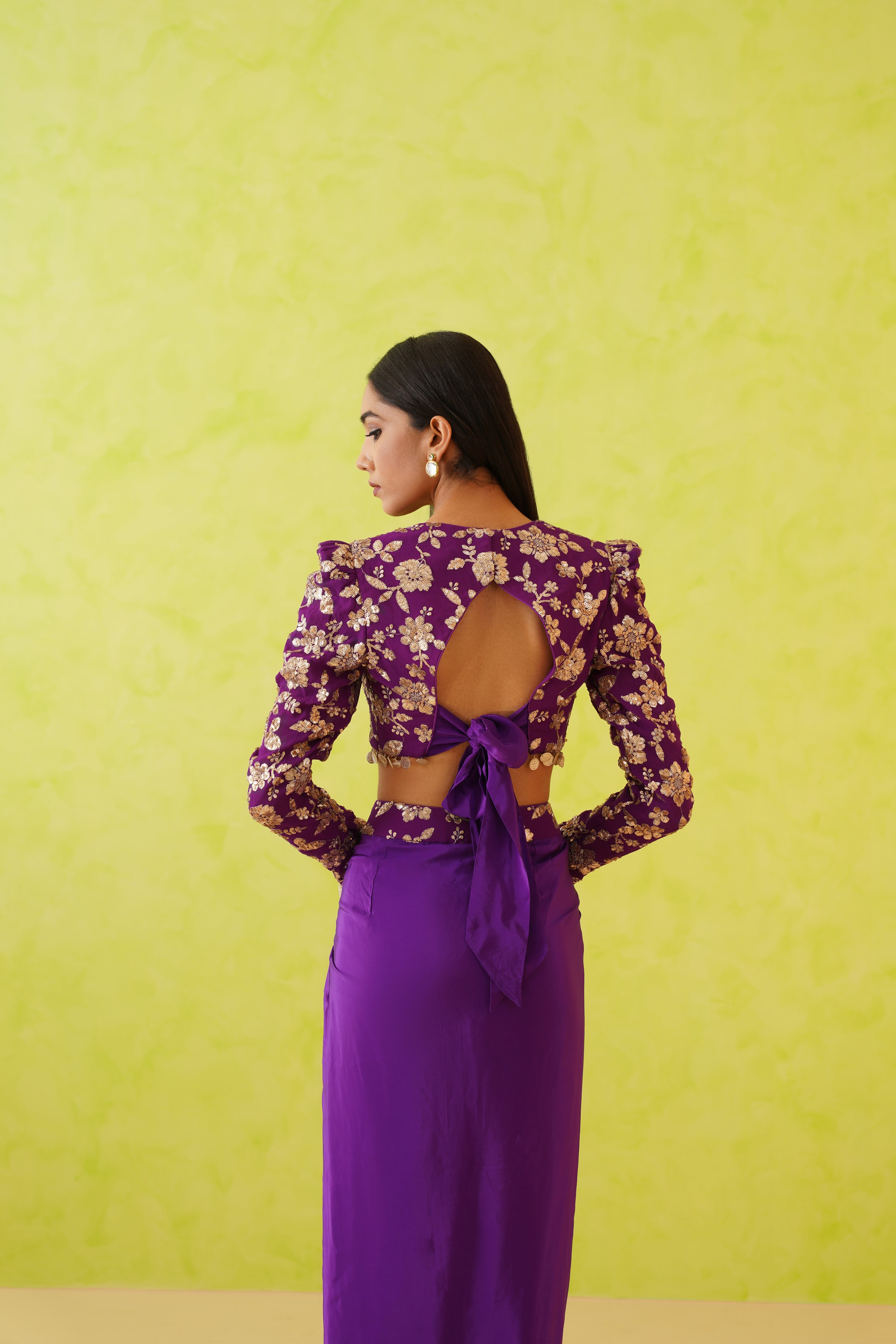 Deepika Chadhai's luxury dhoti and blouse set in a striking purple hue, showcasing intricate embellishments and a chic, contemporary silhouette.