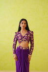 This exquisite purple dhoti and blouse set, made from luxurious crepe, combines a stylish flowy dhoti with a beautifully embellished top for a stunning look.