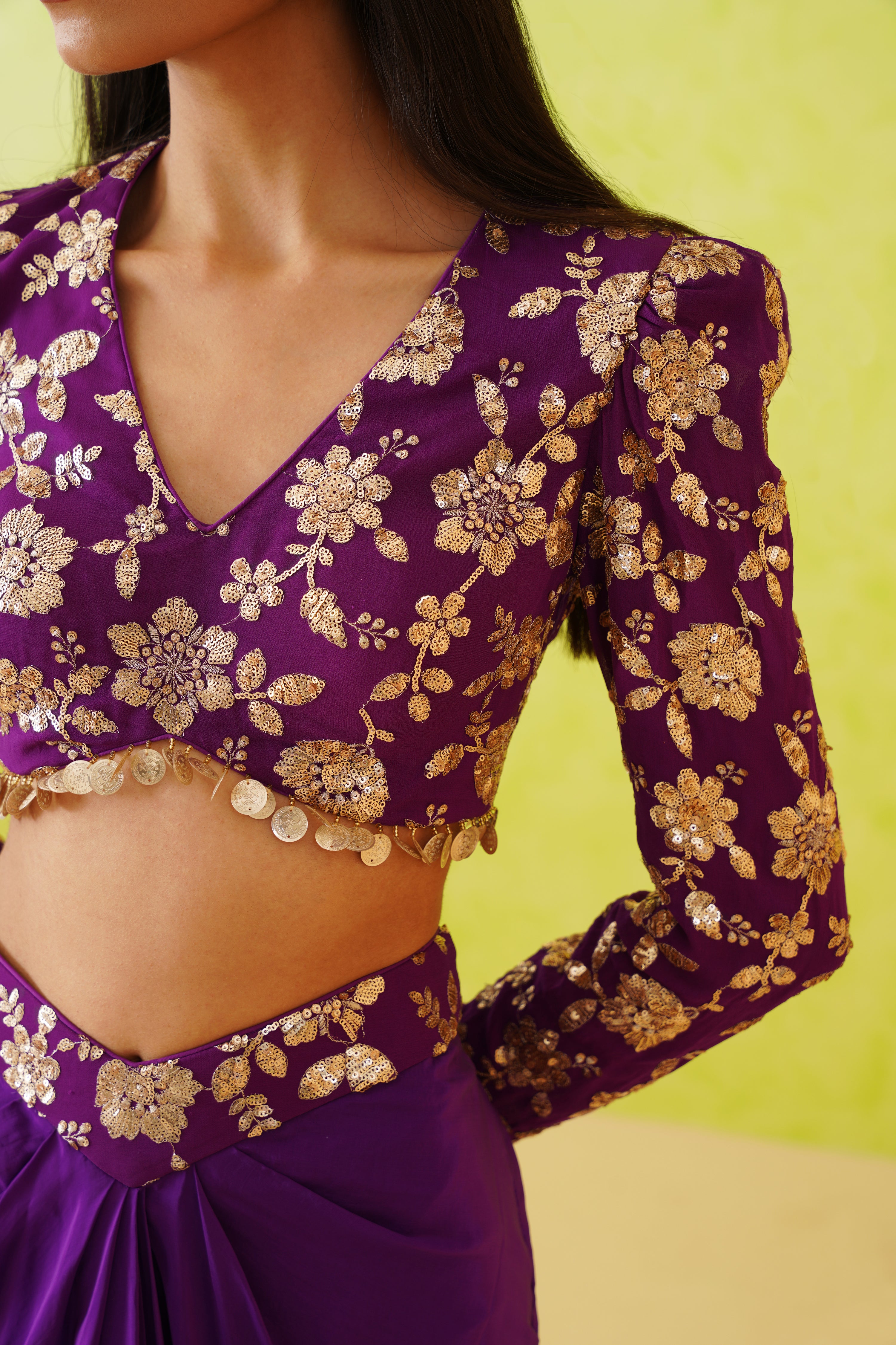 A luxurious purple ensemble by Deepika Chadhai, featuring a draped dhoti and an intricately adorned blouse, ideal for making a bold statement at any festive occasion.