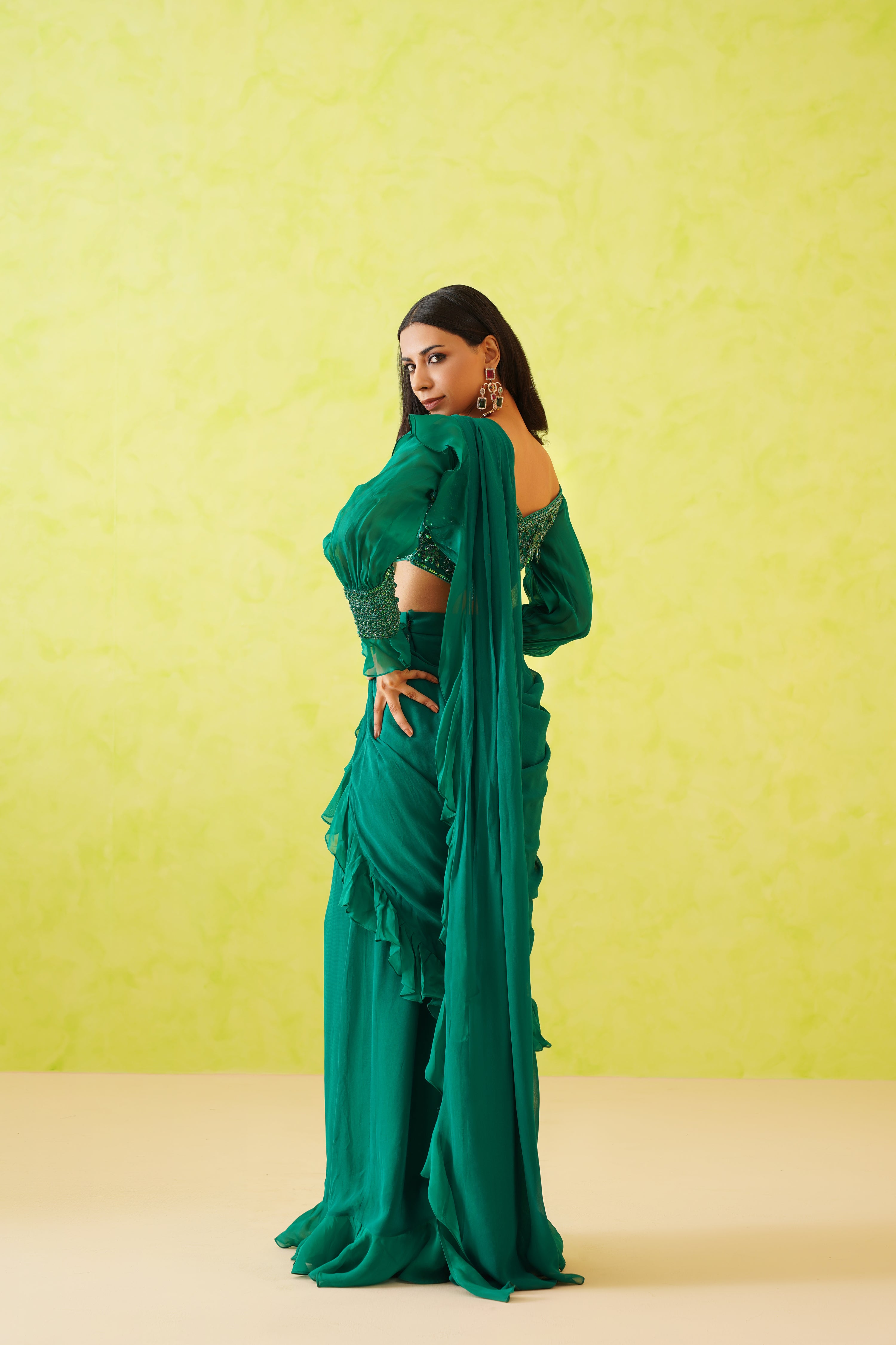 Flowy, full-length modern saree in vibrant green, designed with a stylish silhouette for a sophisticated appearance.