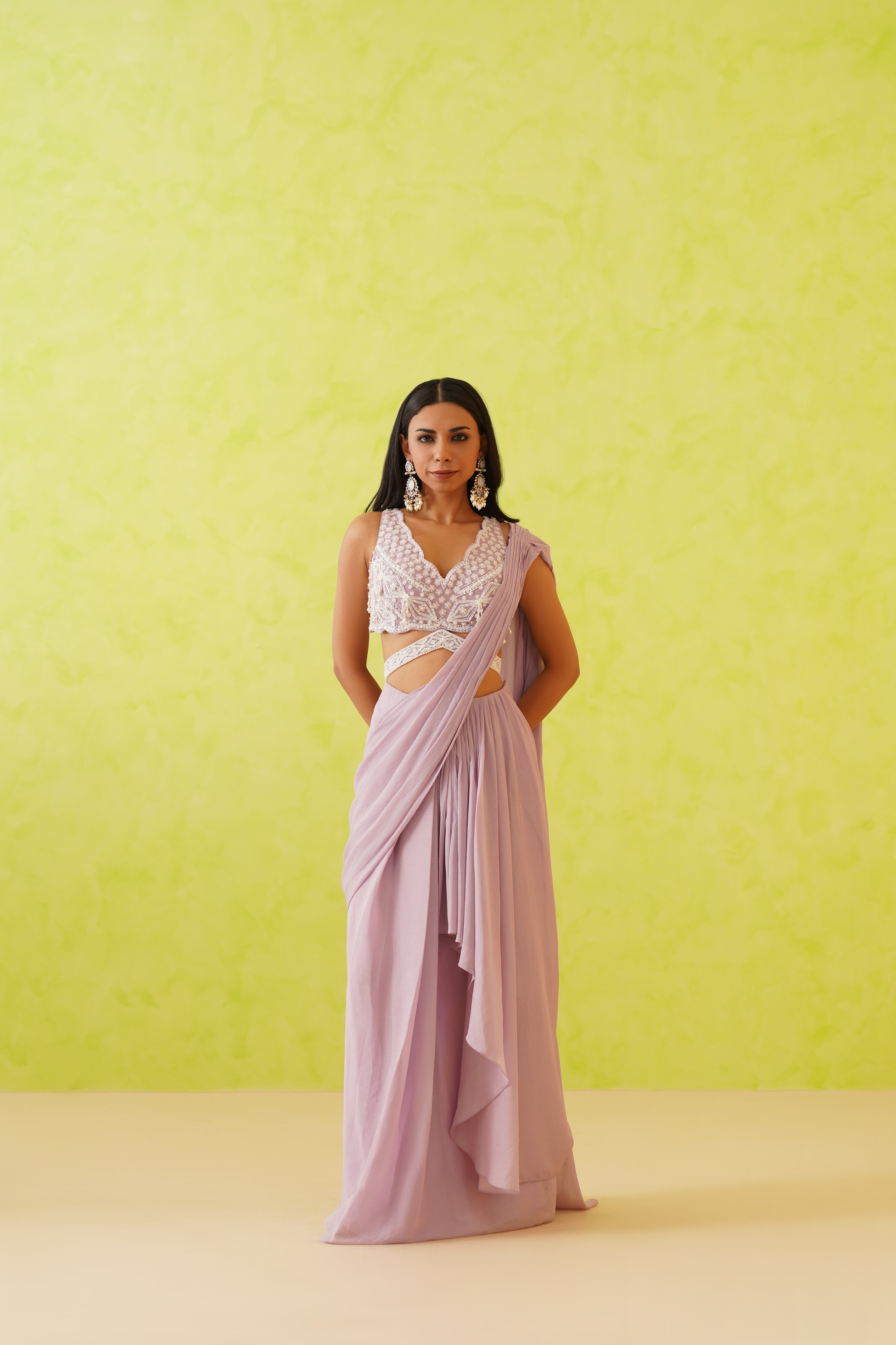 Stunning mauve draped saree paired with an embellished blouse featuring white sequins, crystals, and pearl detailing in floral patterns.