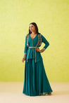 A flowing green sharara paired with a long embroidered top and a matching jacket.